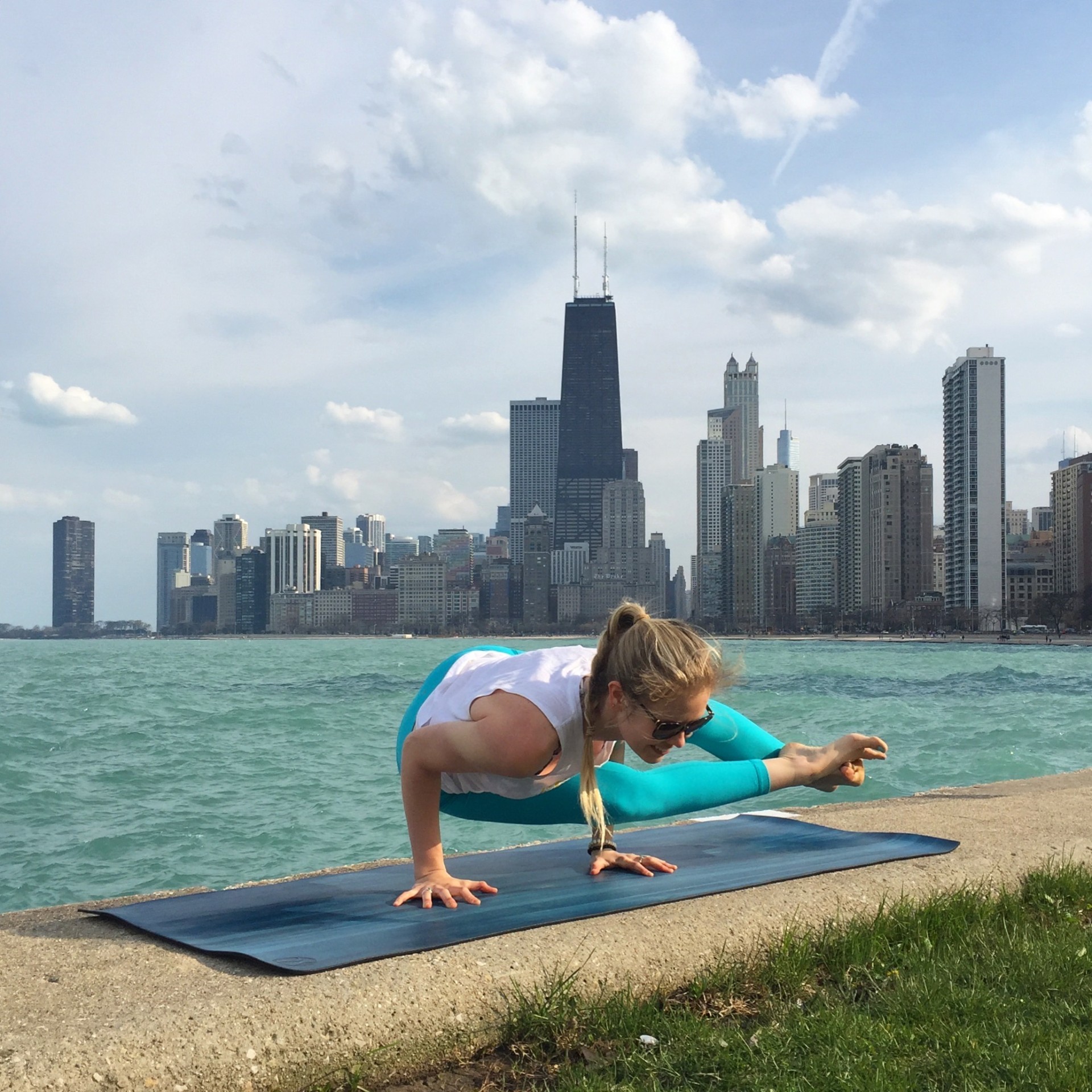 Ellery Long in an arm balance by the Chicago lakefront