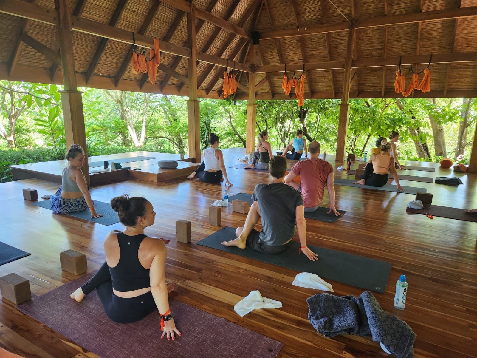 Yoga class led by Ellery Long in a tropical pavilion